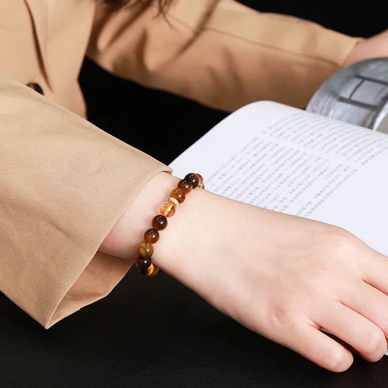 Yellow tiger-eye gemstone bracelet with 8mm round beads in a Jinba geometry design.