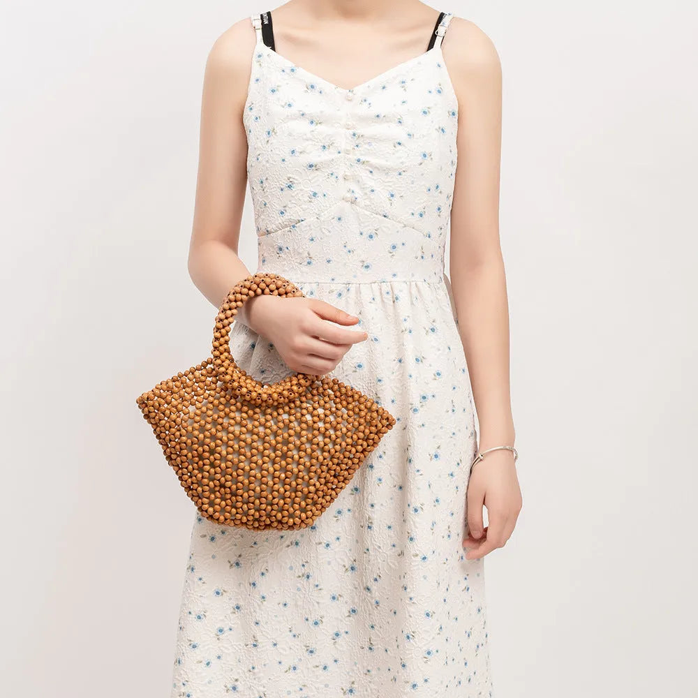 Hand-woven maple wood beach bag with wooden bead decoration in dumpling shape