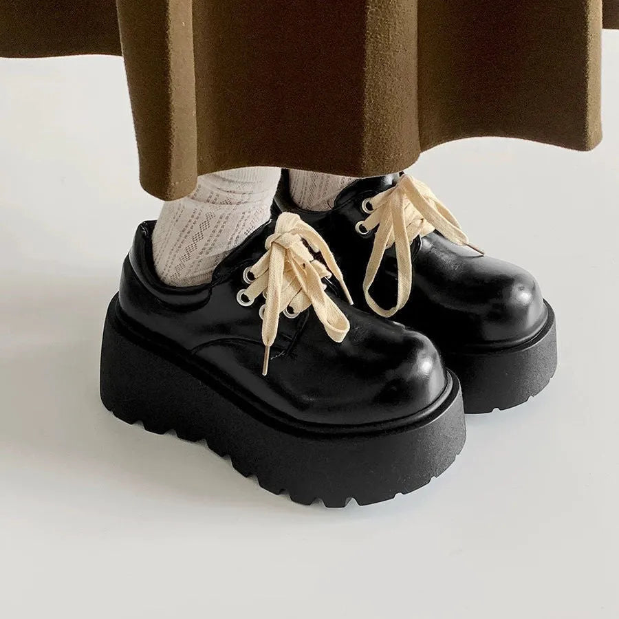 Women's matte black lace-up platform ankle boots with a thick sole and round toe.