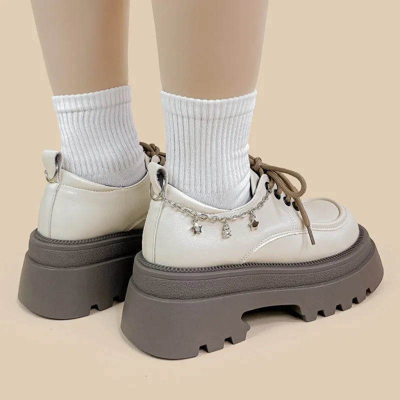 White women's platform Mary Jane shoes with a chunky heel and front lace-up fastening.