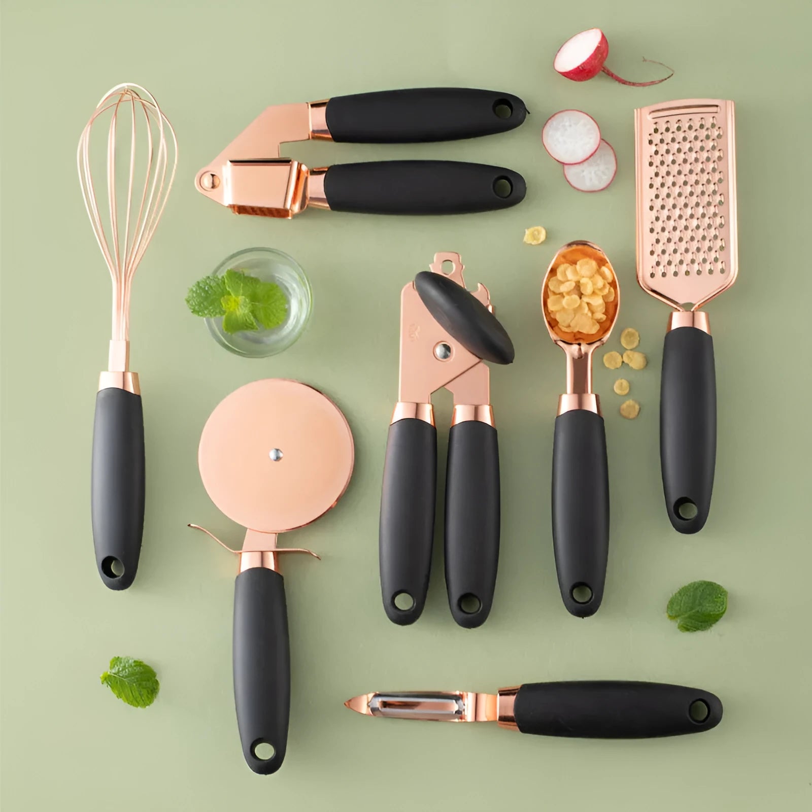 Seven-piece stainless steel kitchen tool set with copper handles on a cutlery rack, in rose gold colour.