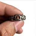 Hand-forged copper Grotto Buddha ring with a rock texture band.