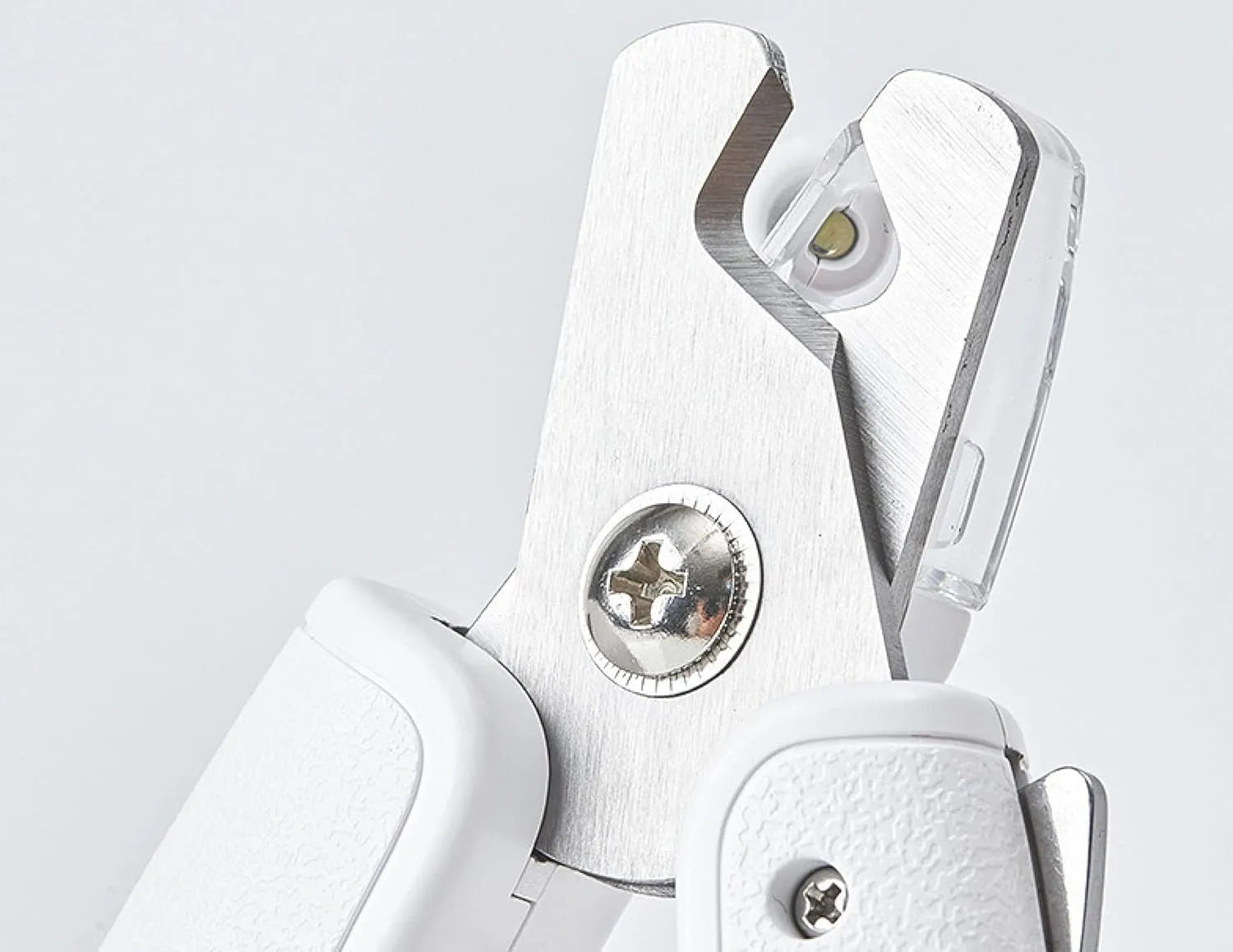 White pet nail clippers with LED light, transparent guard, and built-in file for cats and dogs.