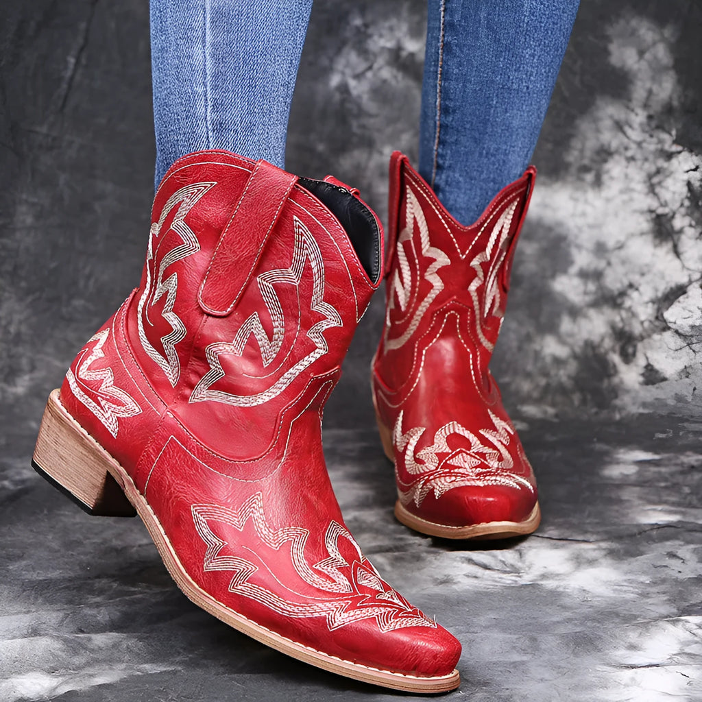 Women's blue embroidered cowboy boots with a low wedge heel and pointed toe.