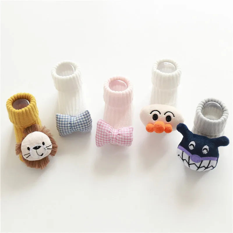 Cotton baby socks in multiple colours and designs including a panda pattern and a blue bow.