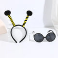 Yellow bee-themed party costume headband and glasses set on cloth material