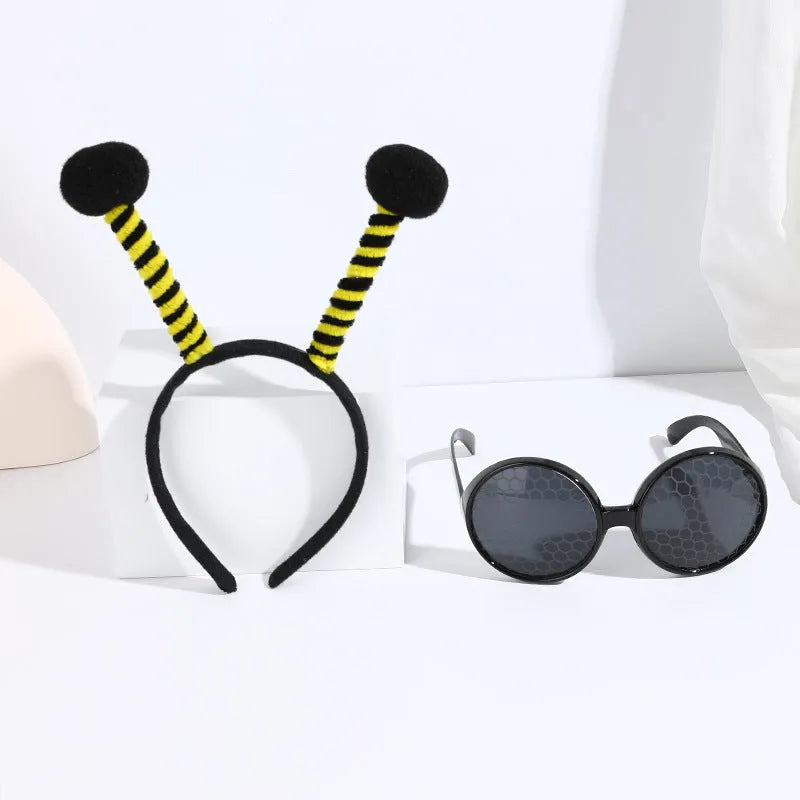 Yellow bee-themed party costume headband and glasses set on cloth material