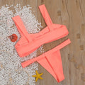 Solid colour split bikini swimsuit in orange on a model, showing two-piece design with nylon fabric