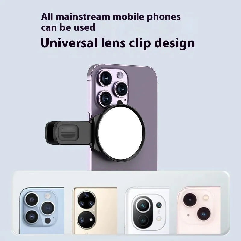 Black mobile phone rear camera self-timer mirror clip with plastic and glass construction, shown attached to a phone.