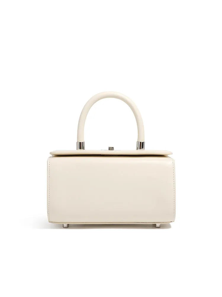 Structured leather women's crossbody bag in a clamshell design, shown in one of four colour options.