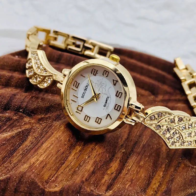 Women's stainless steel watch with round dial showing gold surface and vachette clasp