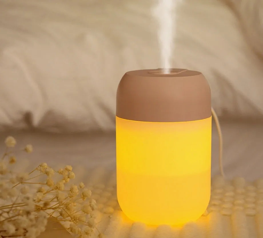 White cylindrical USB mini humidifier with charging cable