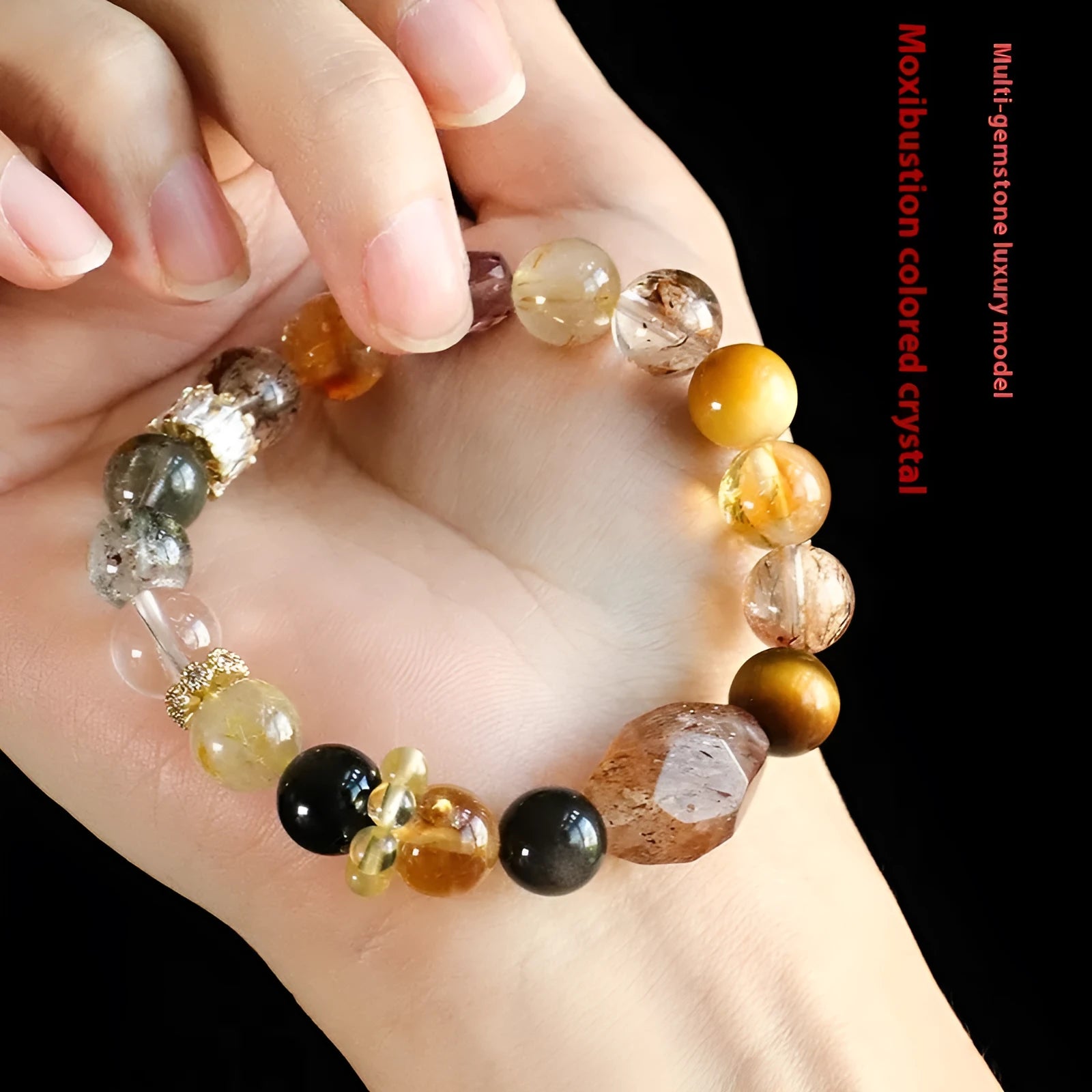Natural Duobao crystal bead bracelet with black and gold beads on a woman's wrist.
