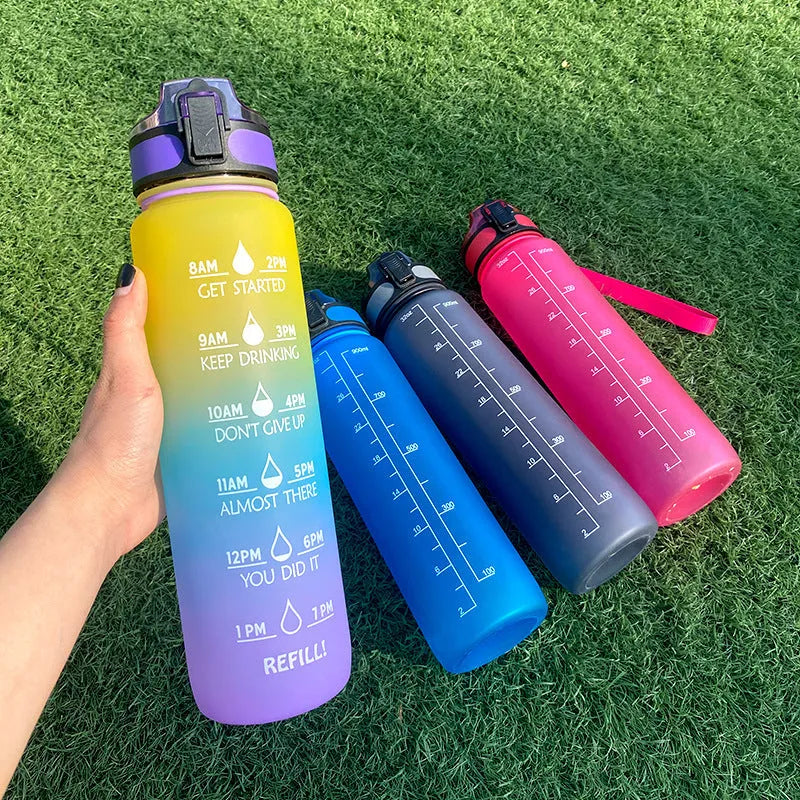Blue and red gradient 1-litre Tritan sports water bottle with time markers and a black bounce cover lid.