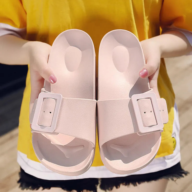 Women's grey blue EVA slippers with a buckle strap and soft sole on a white background