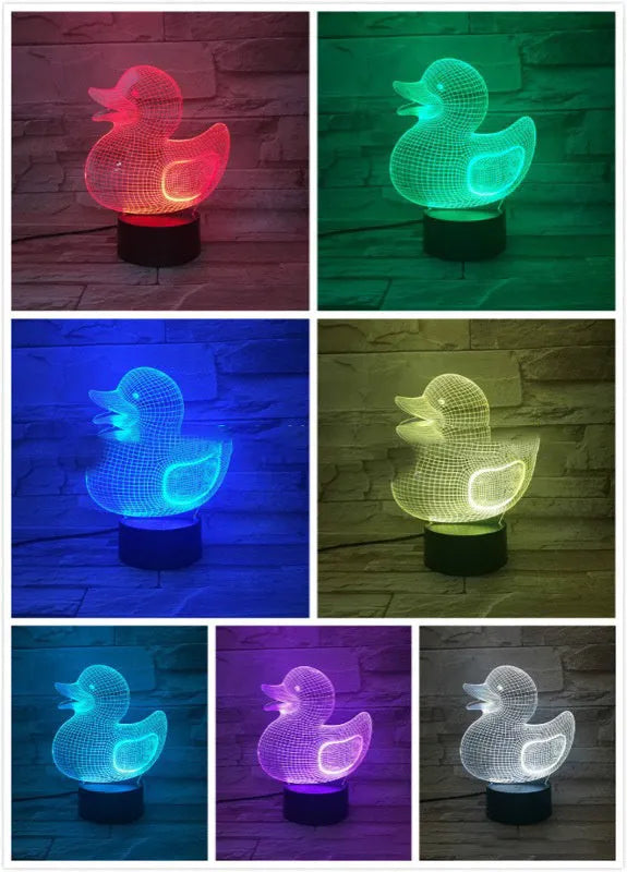Little yellow duck 3D night light with remote control on a table, showing its colourful LED illumination.