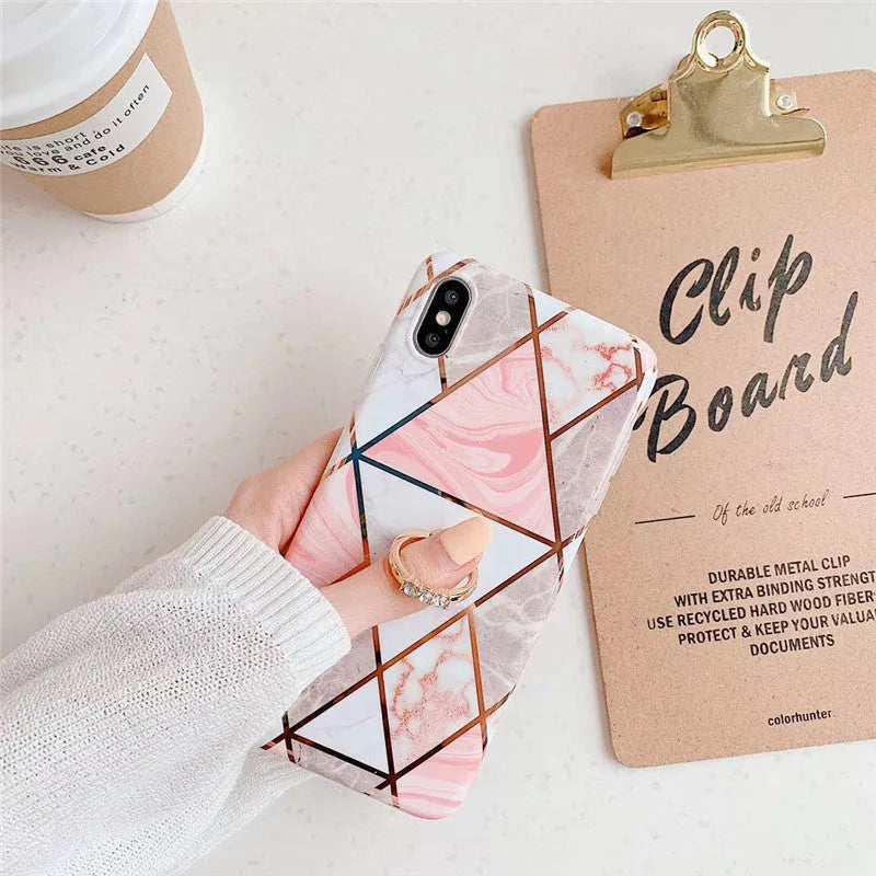 Geometric plating ring on a slim blue iPhone back cover case, showing the stand function.