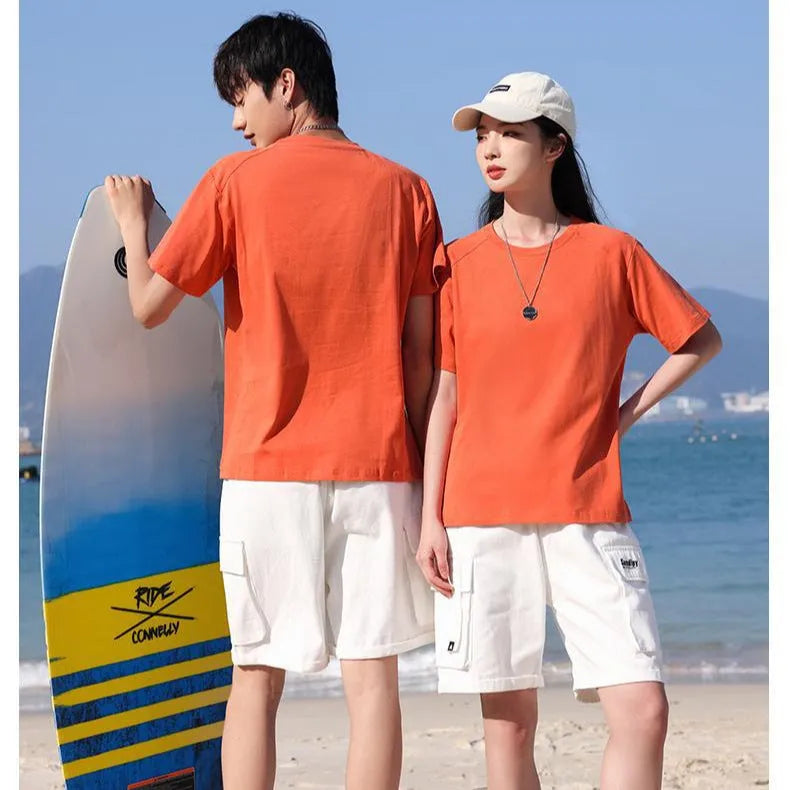 Men's solid colour cotton short sleeve t-shirt laid flat, showing colour options including black, white, and bright orange.