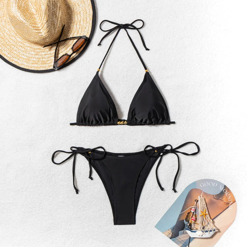 Black women's bikini swimsuit with metal bead detailing on polyester fabric