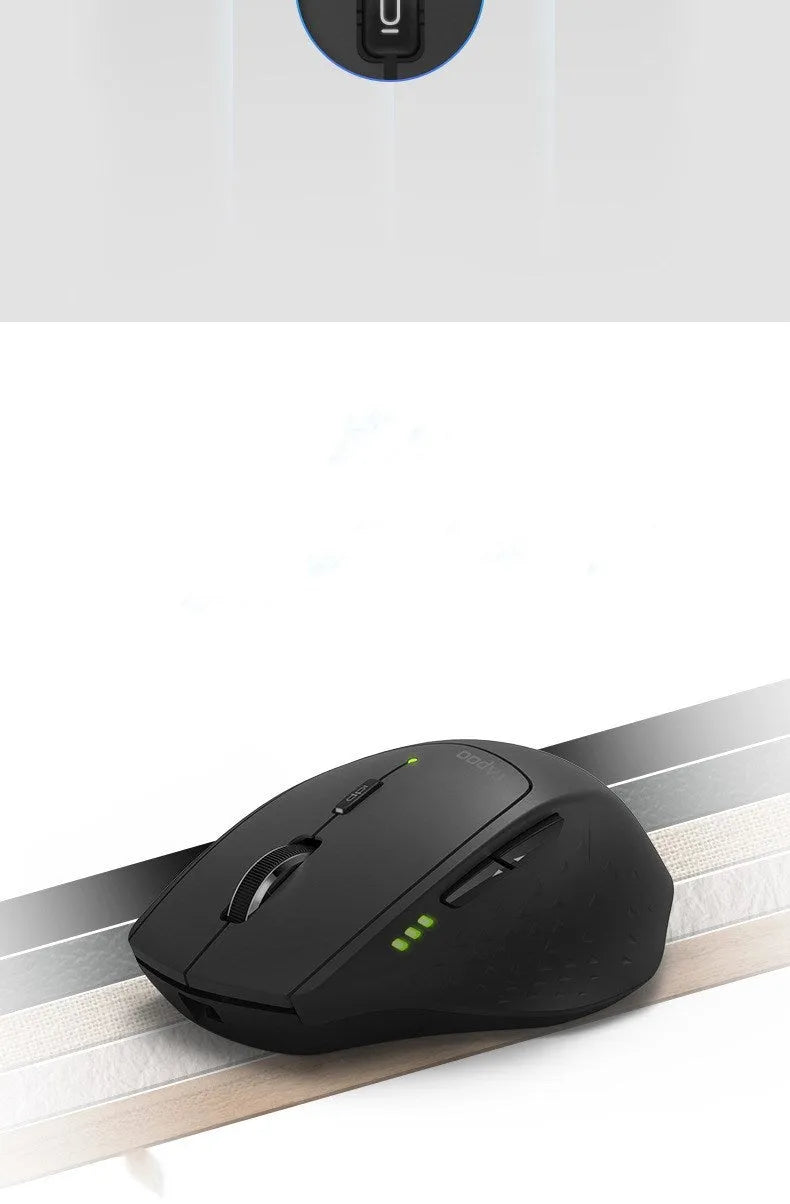 Rapoo MT500 wireless Bluetooth mouse in black with six buttons on a desk surface