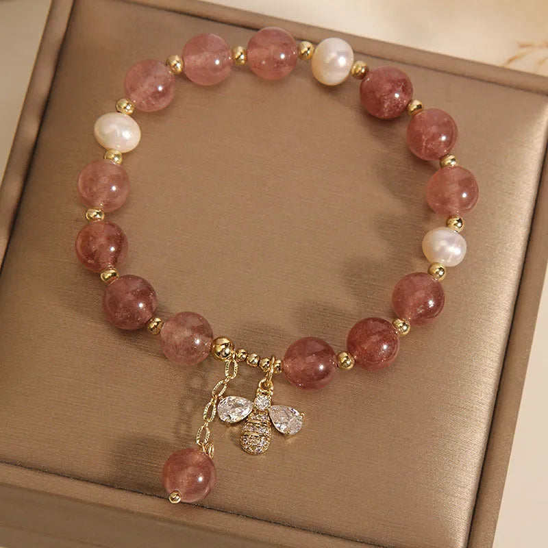 Women's bracelet with strawberry quartz beads, freshwater pearls, and metallic charms in Japanese Korean jewellery style