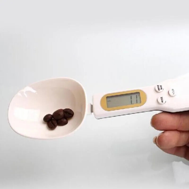 White digital spoon kitchen scale with LCD display showing weight measurement