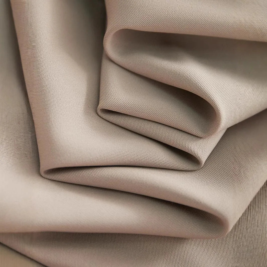 Wide-leg women's trousers in milk apricot with stacked hem design and pockets, flat lay view