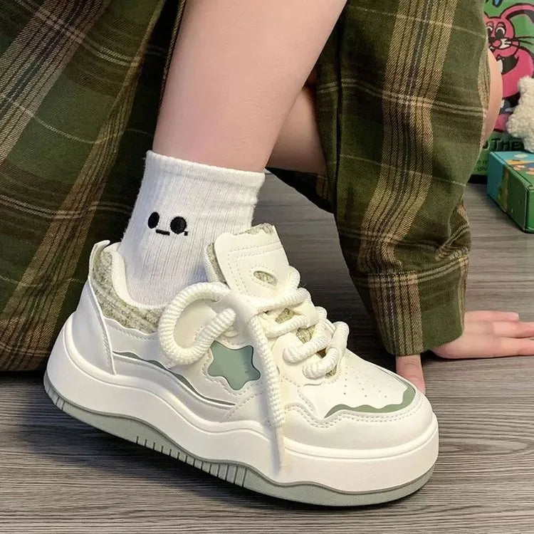 Women's green platform sneakers with lace-up front and round toe design on rubber sole