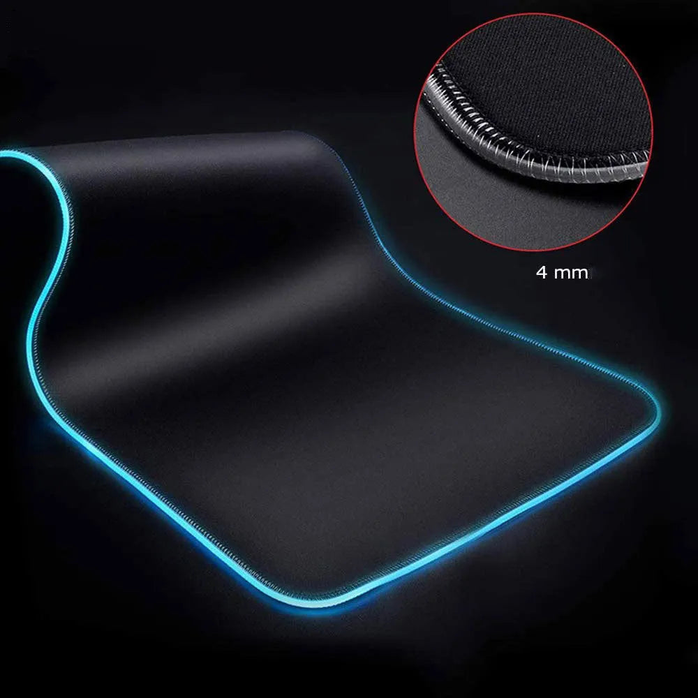 Symphony RGB luminous gaming mouse pad with starry sky pattern on a desk, showing USB cable.