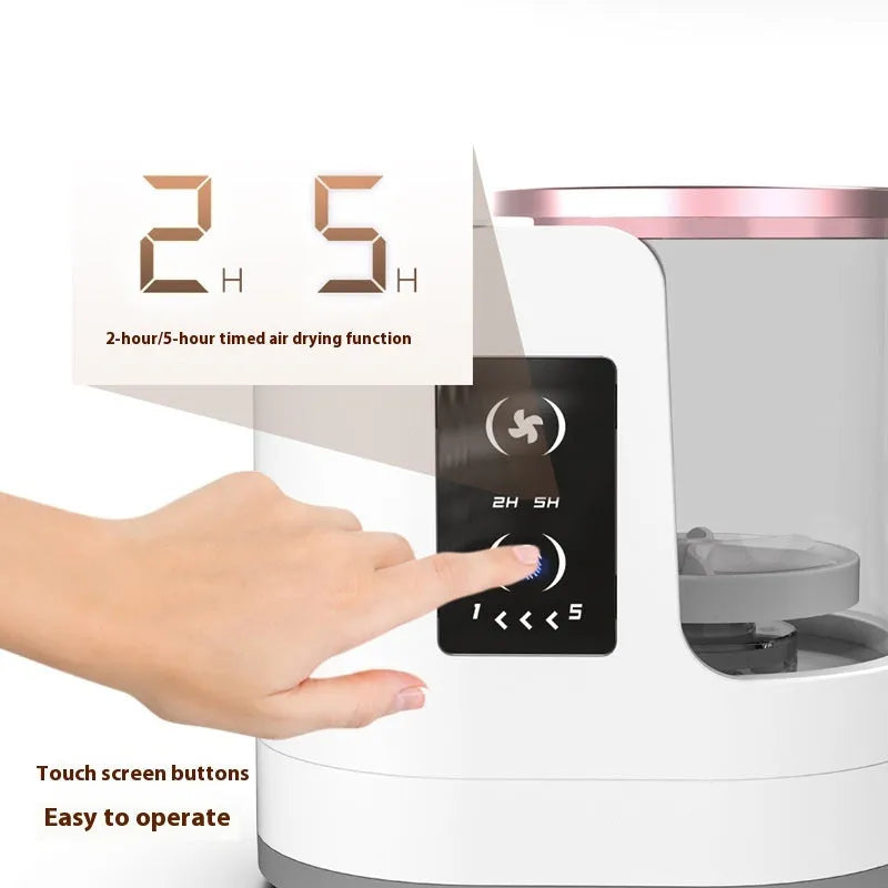 White rechargeable electric makeup brush cleaner with drying chamber on a vanity table.