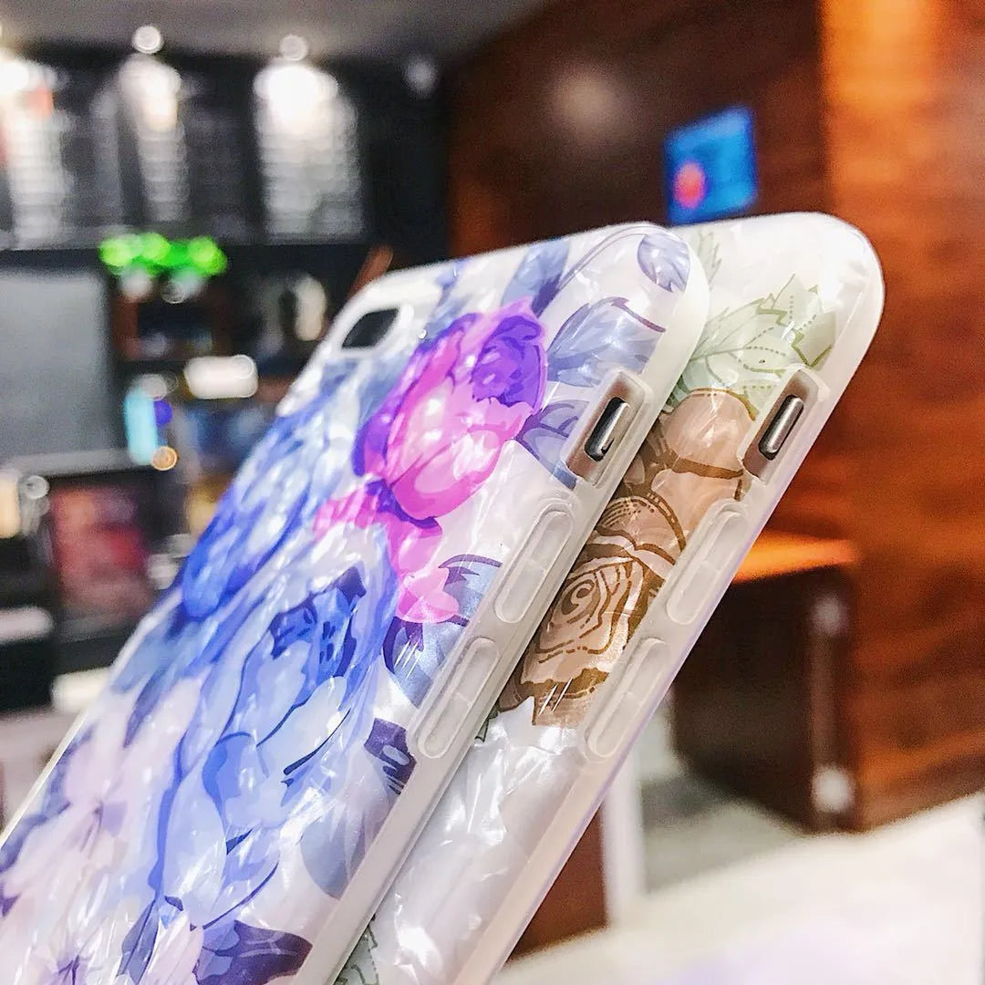 Dream Shell soft TPU silicone iPhone case with a rose flower design on the back, shown in brown colour.