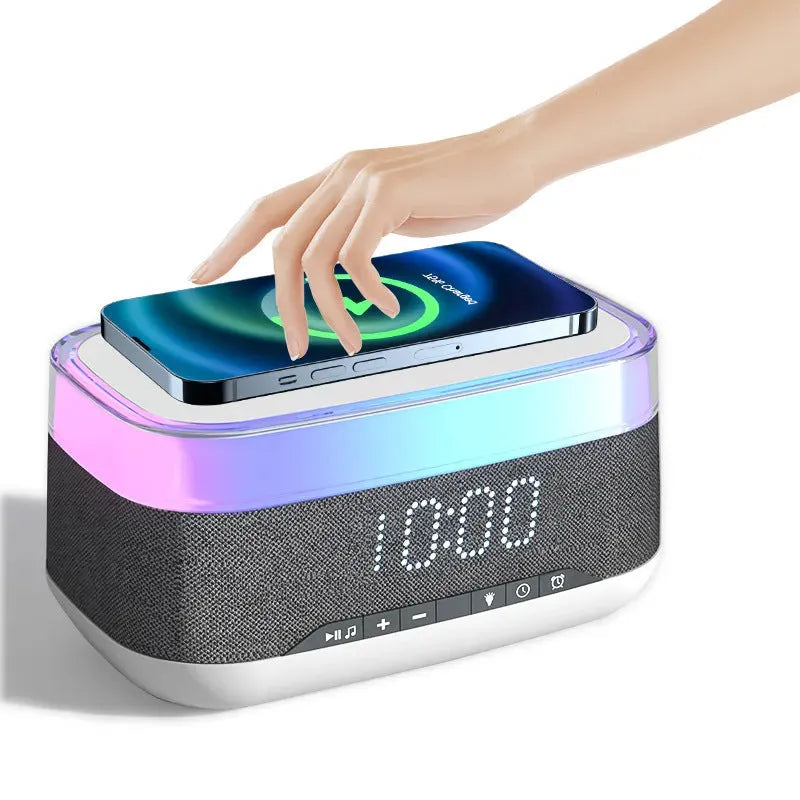 White multifunctional alarm clock unit with Bluetooth speaker and wireless charging pad.