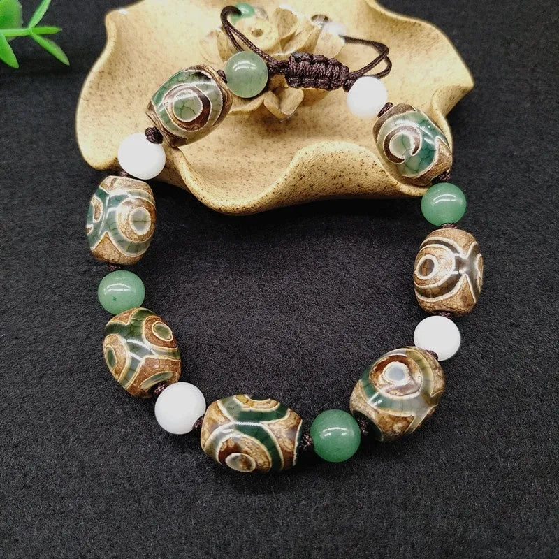 Green agate ethnic bracelet with hand-woven beads showing geometric patterns and three-eye design details