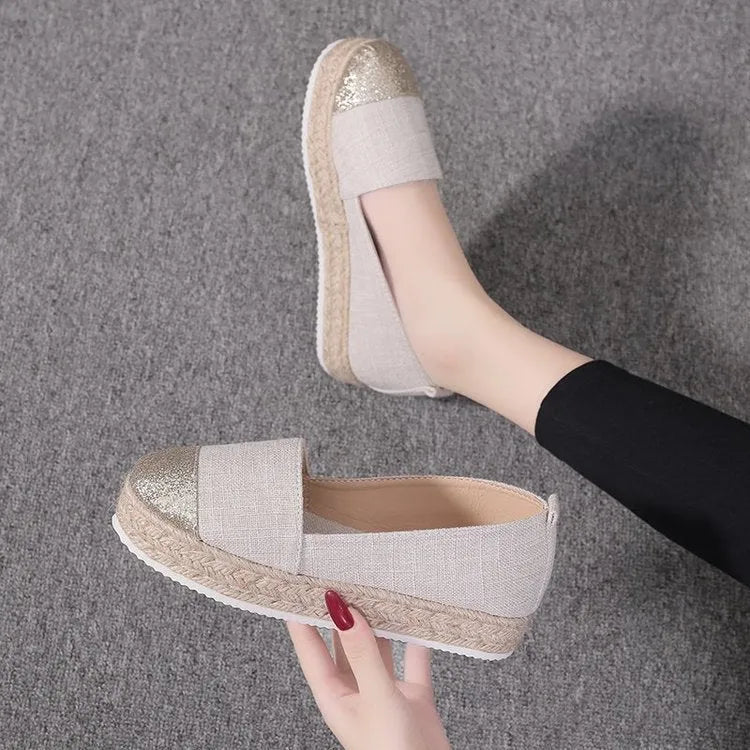 Plus size beige and black breathable canvas flat shoes with round toe and slip-on design.