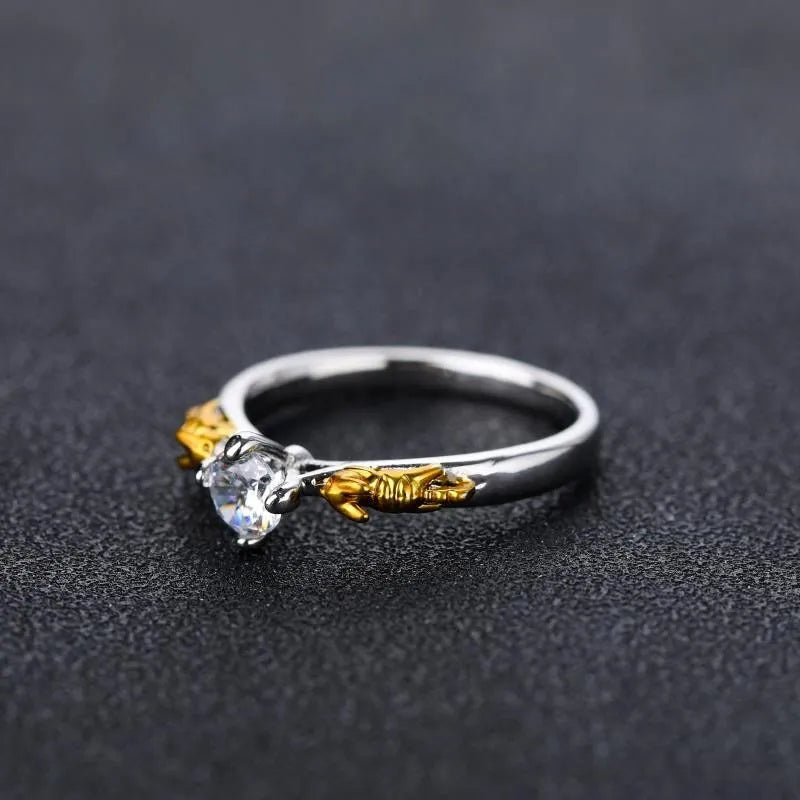 Copper crown fashion ring with black gold finish on a hand.