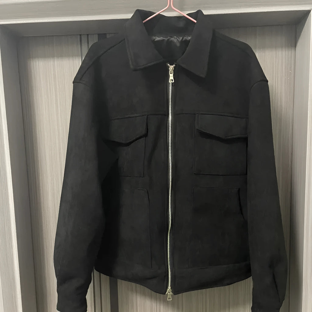Slim fit camel coloured jacket with zipper pockets on a model.
