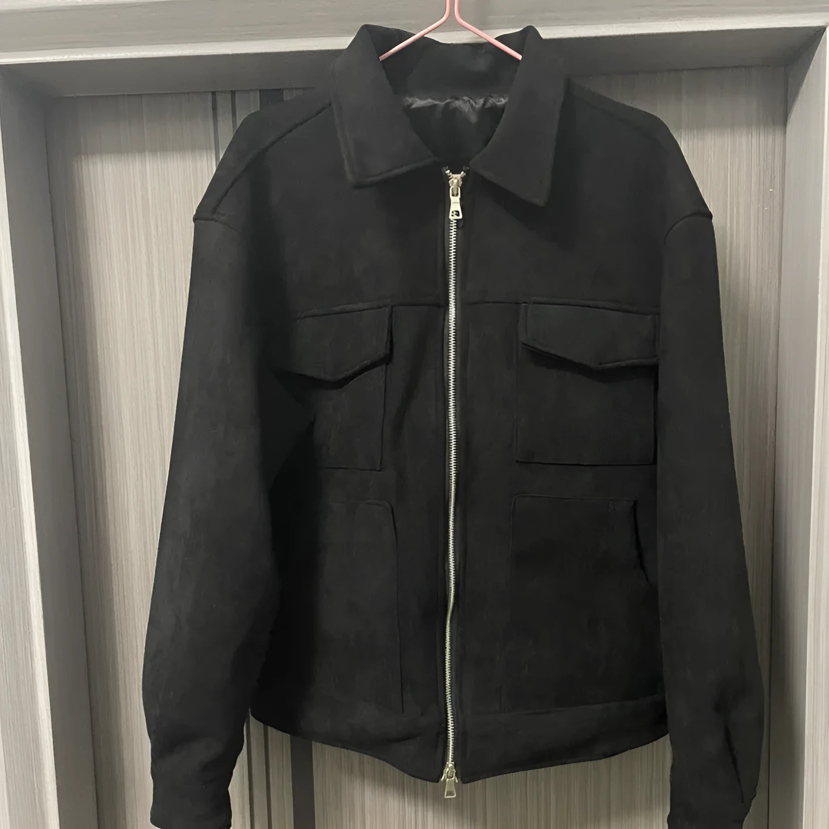 Slim fit camel coloured jacket with zipper pockets on a model.