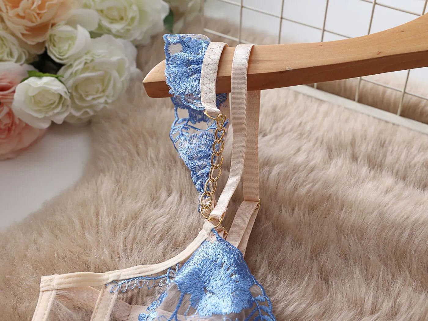 Light blue women's lace push-up bra and matching pants set on a hanger.