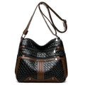 Horizontal square messenger bag with multiple compartments and woven shoulder strap in black with brown trim