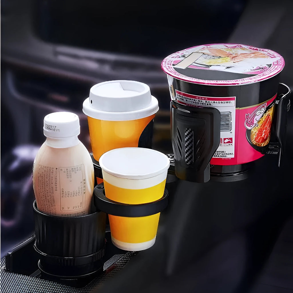 Black adjustable rotating car drink holder with retractable base on a car dashboard.