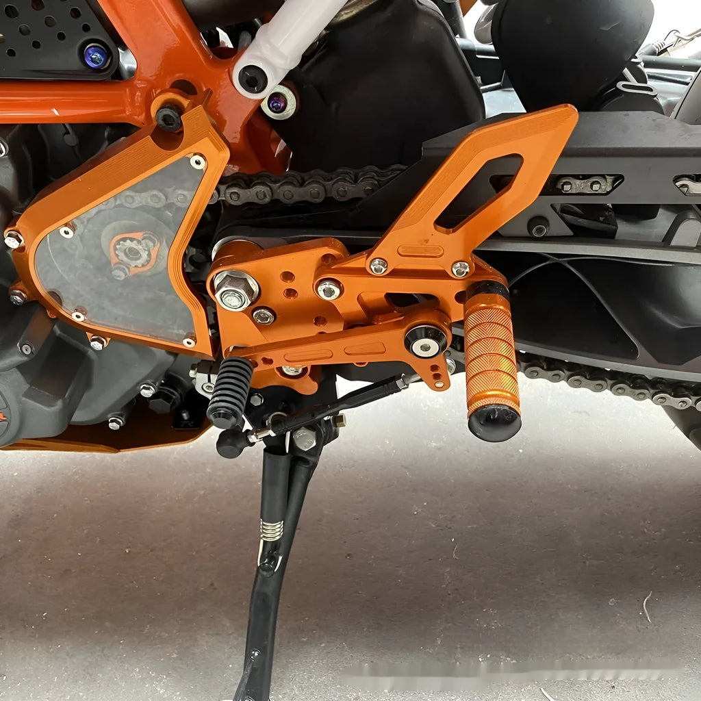 KTM Duke motorcycle pedal support assembly in black and orange for 125 200 250 390 models