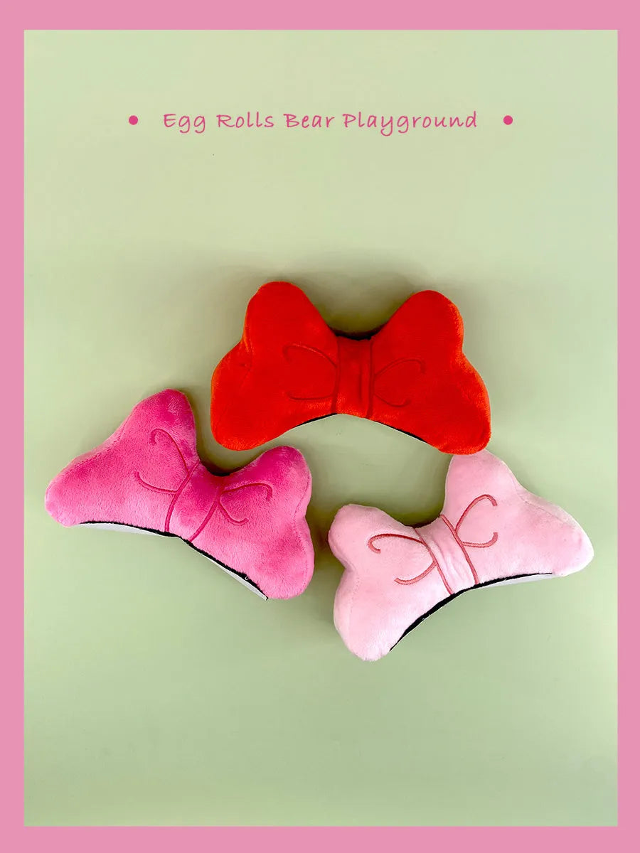 Soft plush bow helmet decoration with elastic loop in red, peach pink, or rose pink.