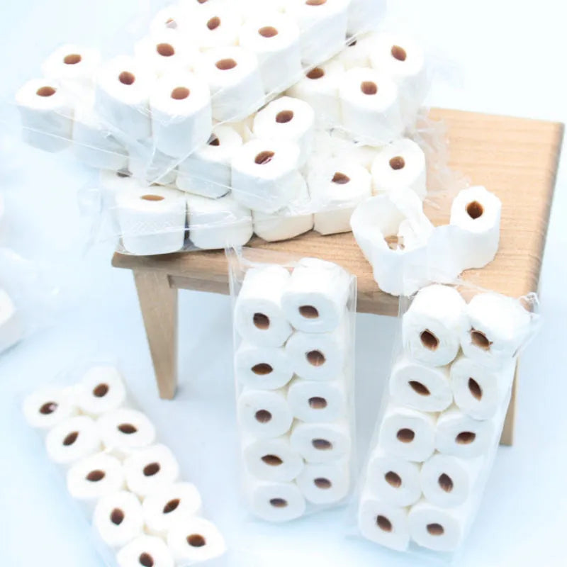 Miniature paper model of a tissue roll for children's play, measuring 30mm by 15mm by 80mm.