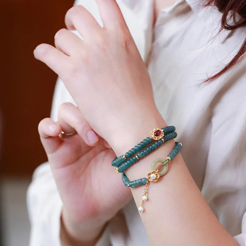 Blue water abacus and jade bead bracelet with tourmaline pearls in a three-ring design.