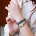 Blue water abacus and jade bead bracelet with tourmaline pearls in a three-ring design.