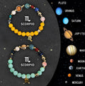 Set of two natural stone beaded bracelets showing different zodiac sign designs.