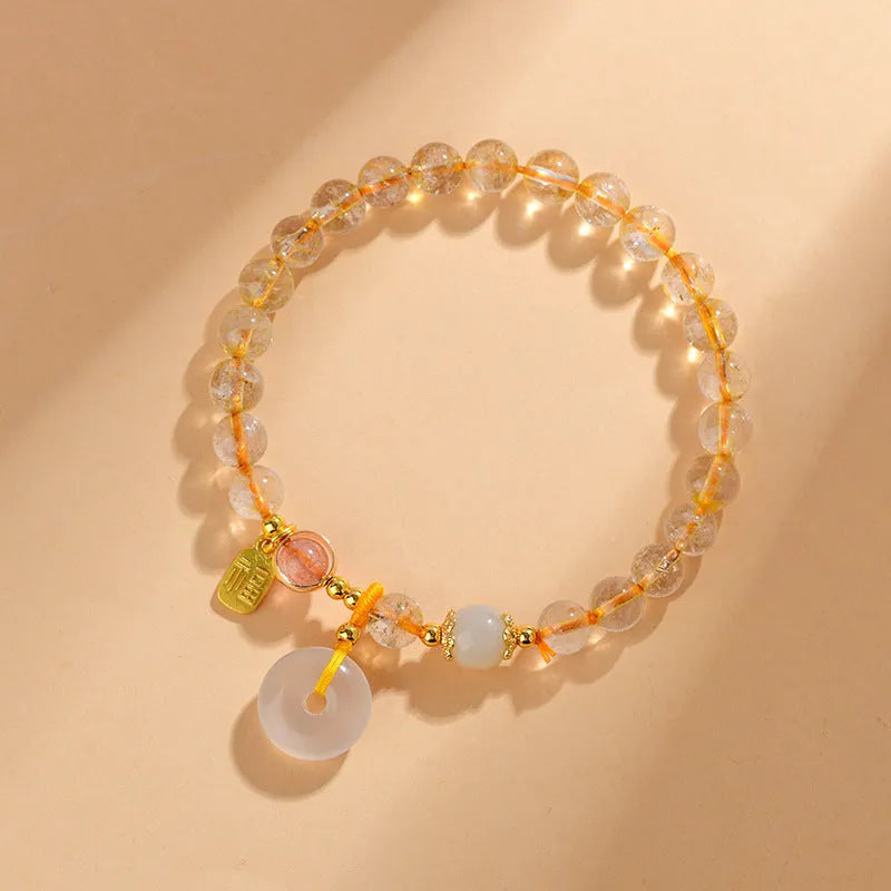 Gold rutilated quartz crystal bracelet with safety buckle and geometric blessing card pendant