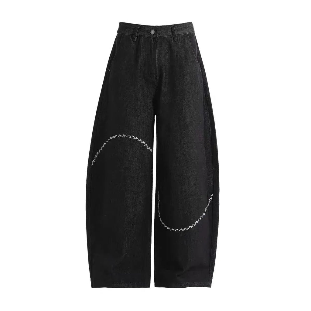 Black straight-leg denim trousers with a mid-waist fit and zip fly, laid flat.