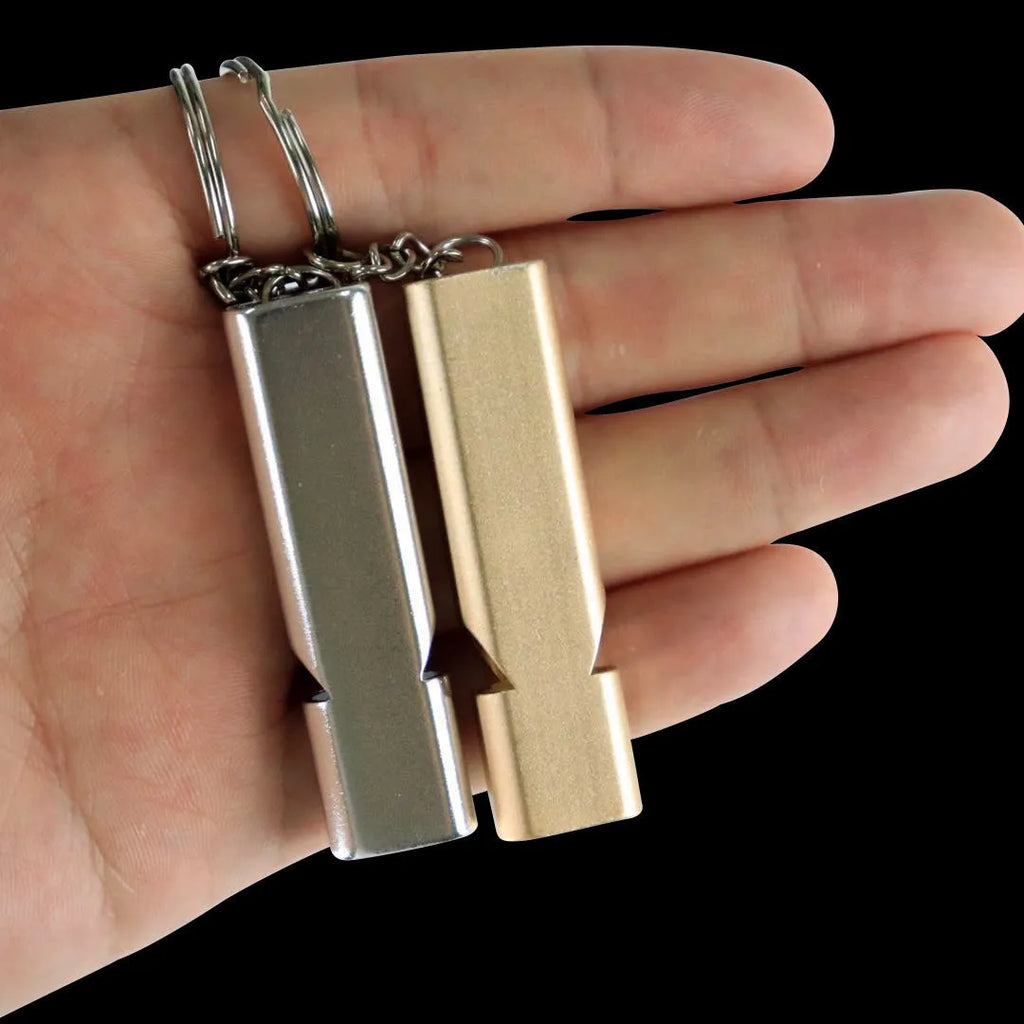Silver and gold aluminium alloy outdoor survival whistle with double hole design.