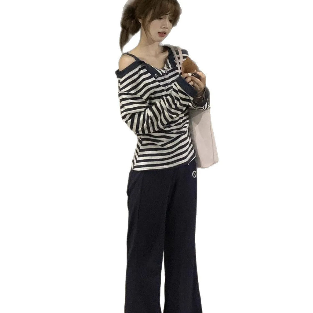 Dark blue women's oversized long sleeve t-shirt with stripes and embroidery detail.